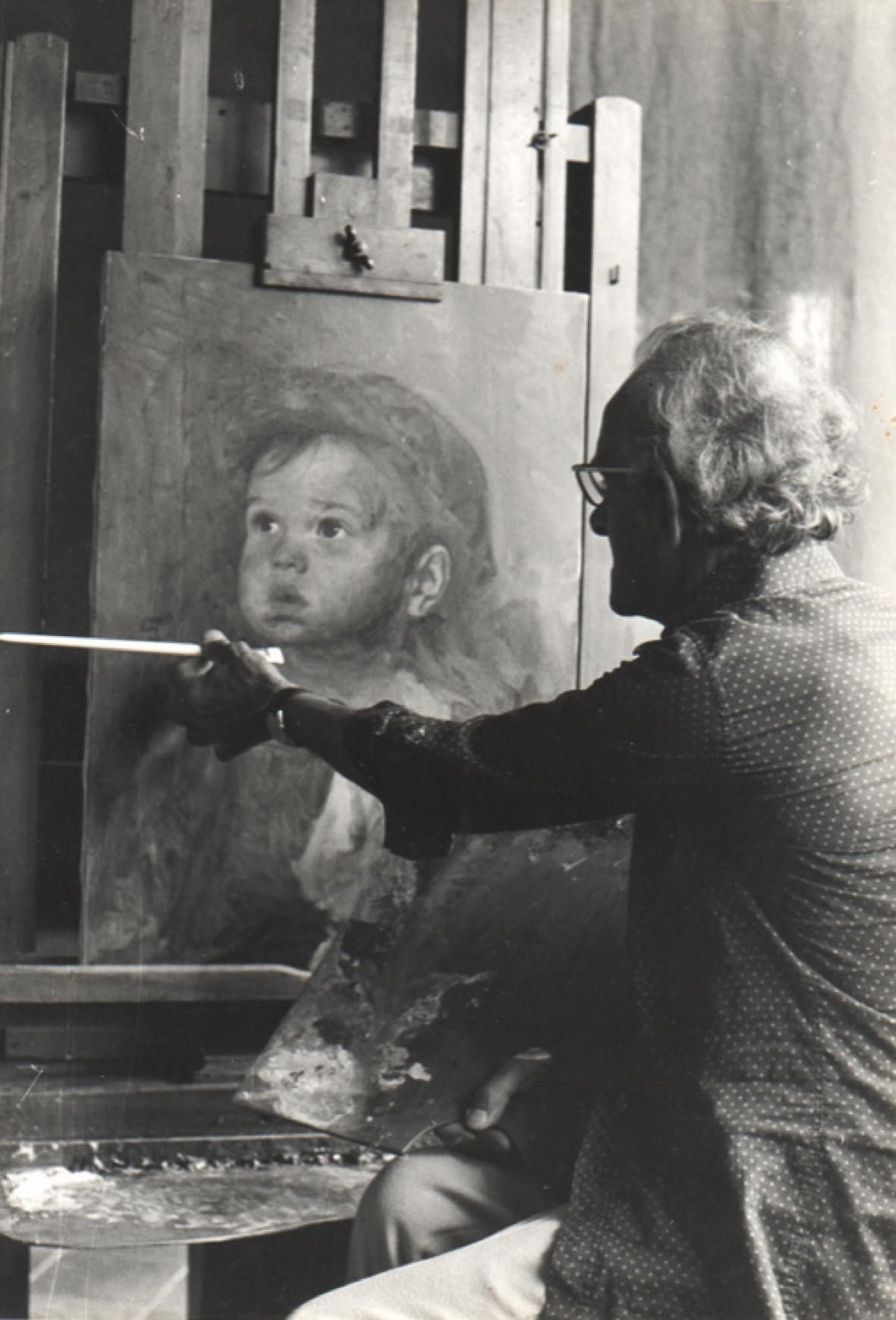 Bruno Amadio painting a "crying boy" artwork in his studio.