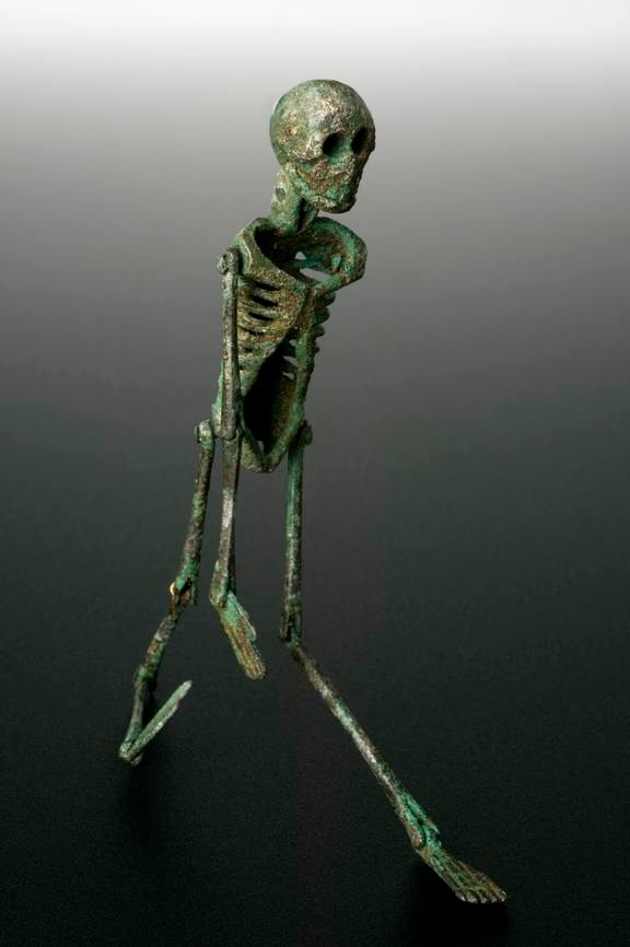 In <em>The Satyricon</em>, Trimalchio plays with a dancing skeleton like this one (c. 199 BCE–500 CE) during his banquet.