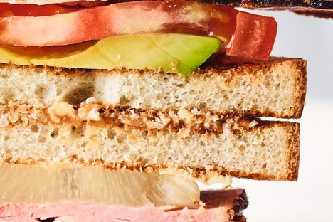 The sophisticated club sandwich combines ham, pineapple, bacon, peanut butter, and avocado.