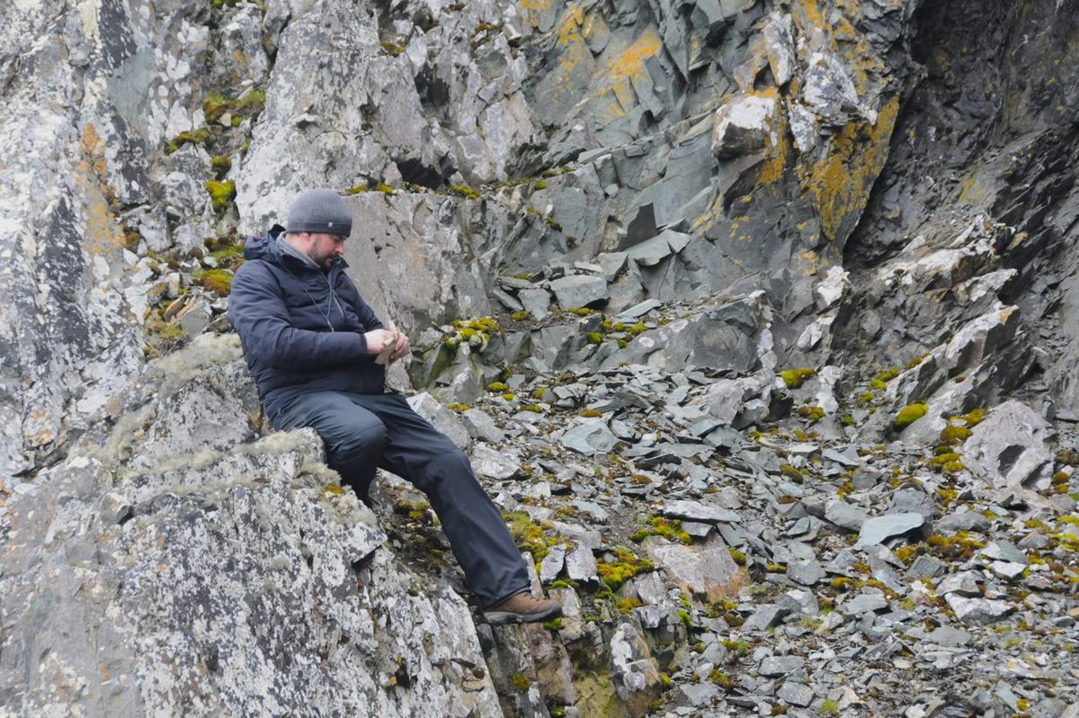 Researcher Felix Grewe, senior author of a recent paper on unexpected discoveries about lichen sex, collecting samples in Antarctica.