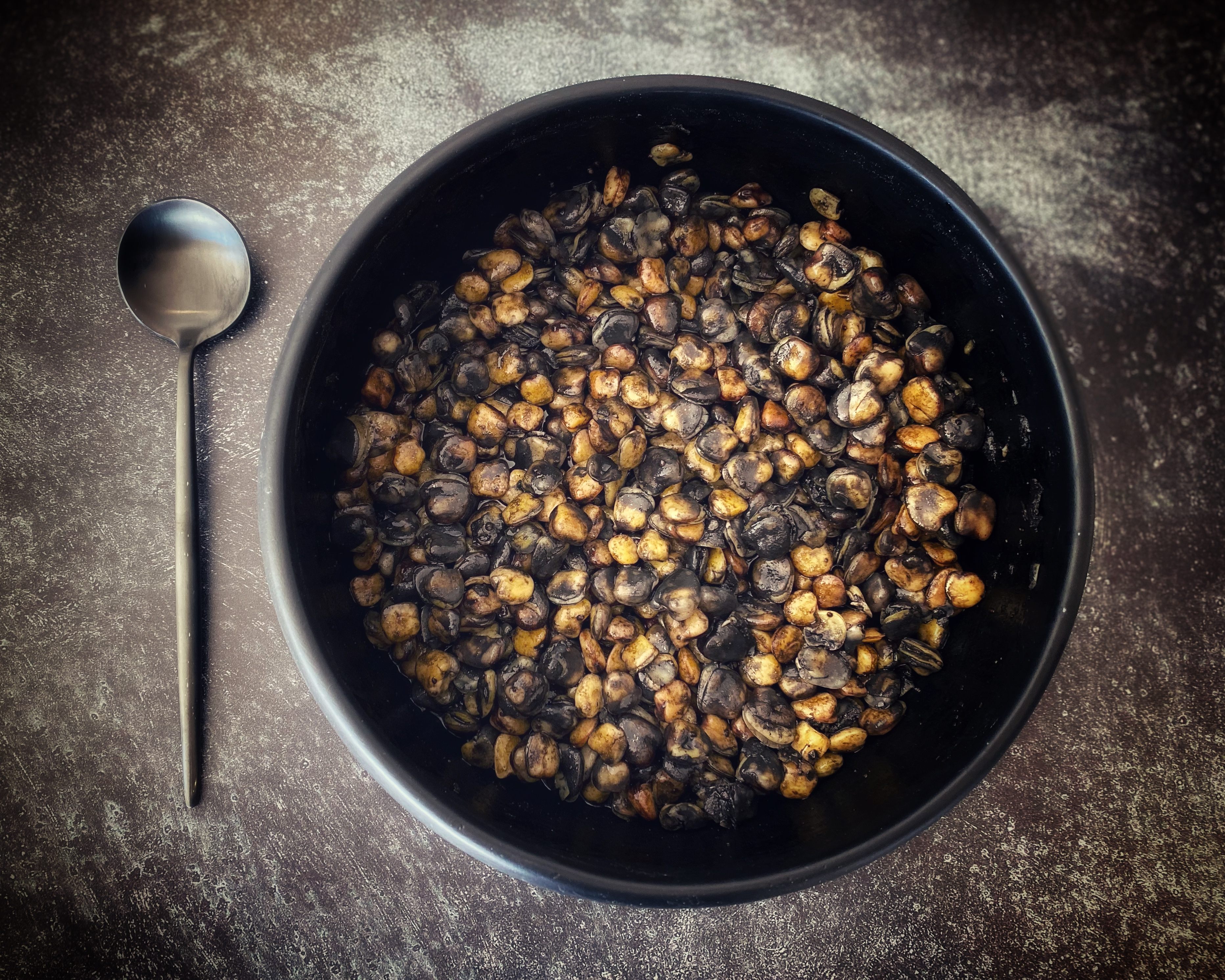 The blackened beans might call to mind the evil spirit–banishing ritual of Lemuria.
