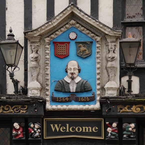 The Bard is represented on the sign.